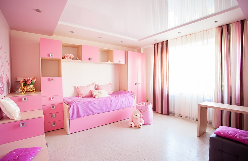 Little girl's room in the colours of pink with bed-closet structure and ceiling spotlights