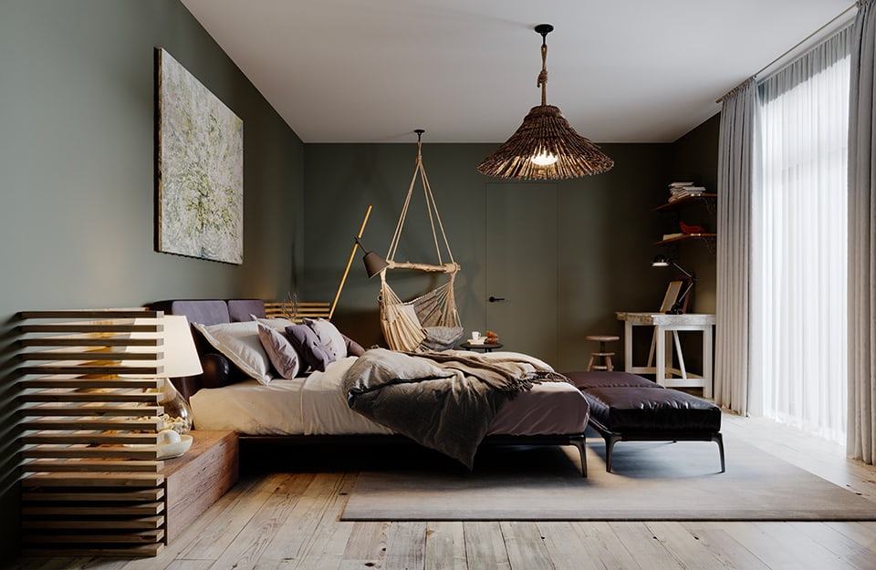 Bedroom in rustic-modern style. The floor is rustic grey parquet, the ceiling white and the walls dark green. The bed has an essential black metal frame and on either side low bedside tables made of rustic wood in the shape of a parallelepiped, with a 'shutter' partition that rises up to a third of the wall. Behind the bed is an abstract painting on green, and on one side of the bed a fabric hammock-style seat hangs from the ceiling. The chandelier is made of rustic wood. At the far end of the room is a rustic white vintage desk, with shelves above it. A large window reaching down to the floor illuminates the room, which is seen from the side;