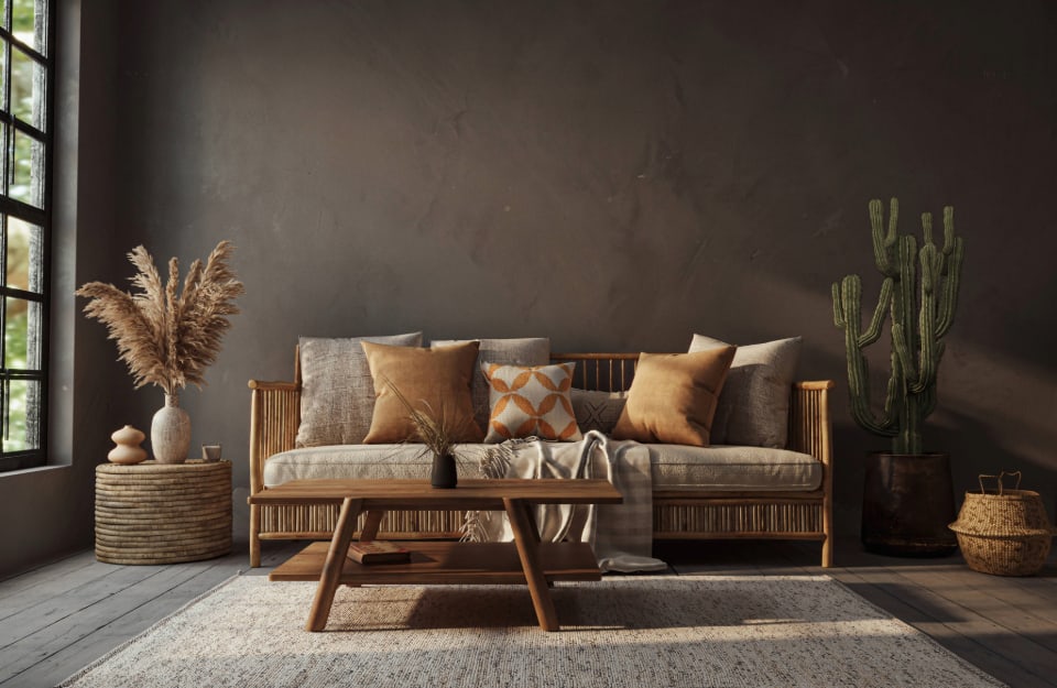 A Boho Chic living room in shades of brown and natural wood, with limewash painted walls;